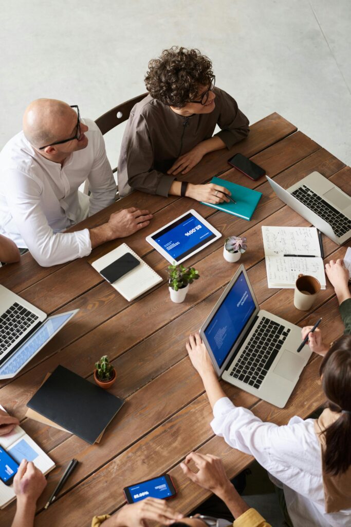 High angle view of a diverse team in a modern office setting discussing a business project.