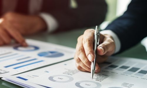 Hands Writing Business Documents Desk Concept